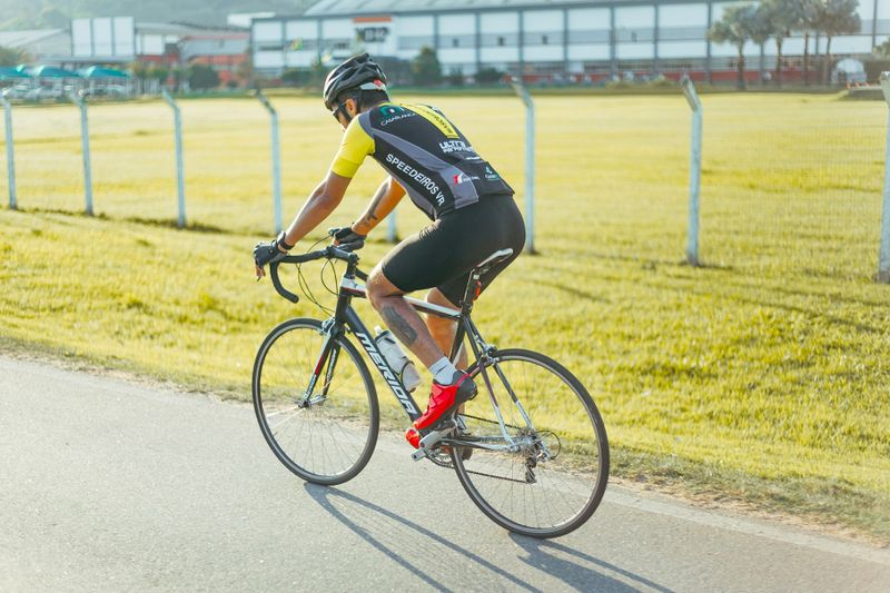 a cyclist riding on the side of a roadway