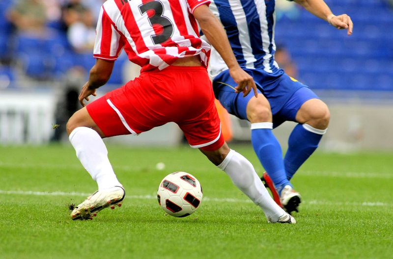 two soccer players on a soccer pitch 