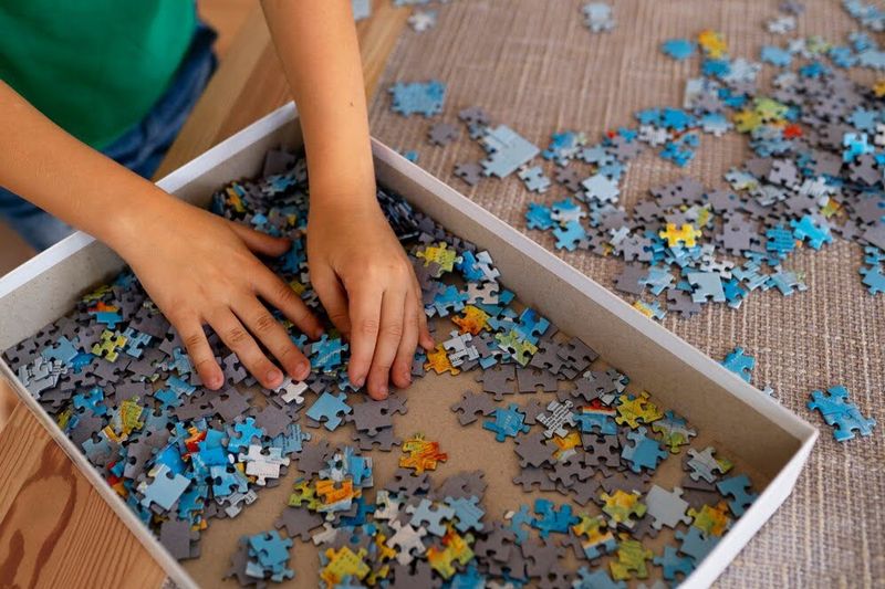 child putting a puzzle  together