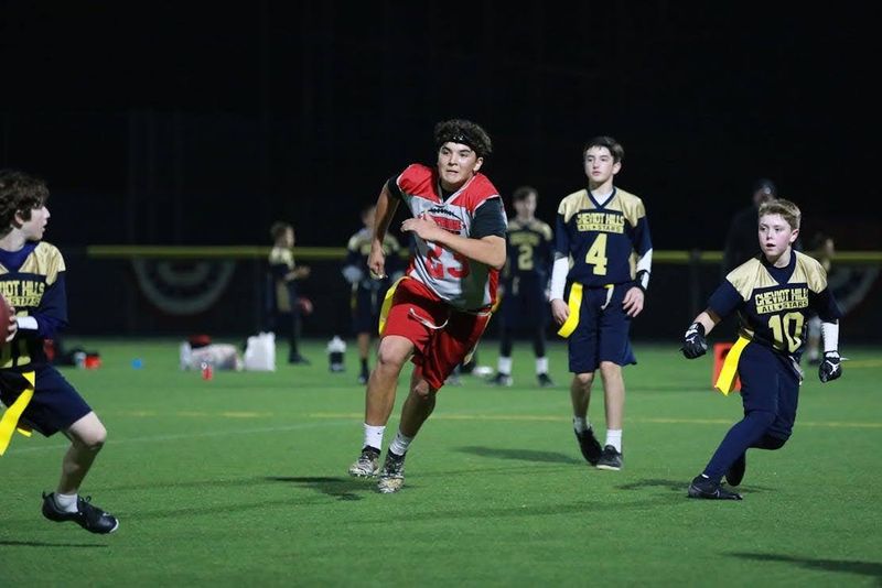 a flag football player running to block a pass