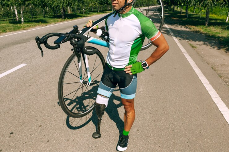 a male athlete holding a bicycle