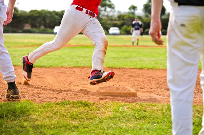 a youth baseball player running to the next base