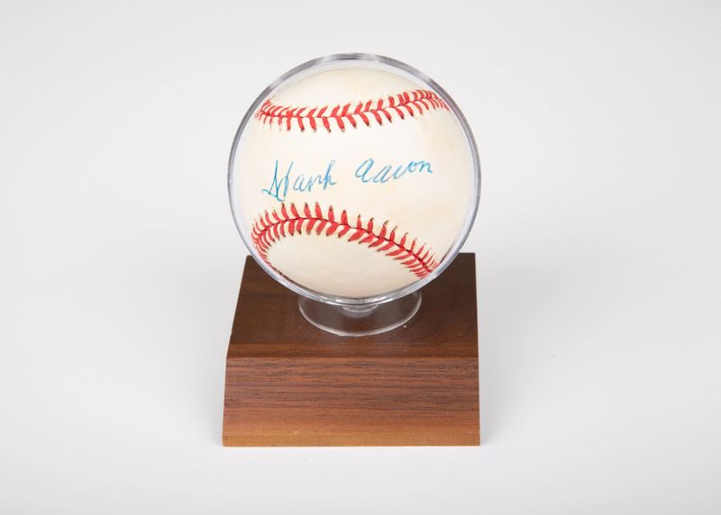 an autographed baseball in a display case