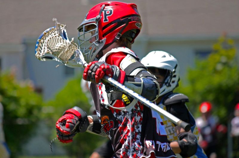 a lacrosse player carrying a lacrosse stick