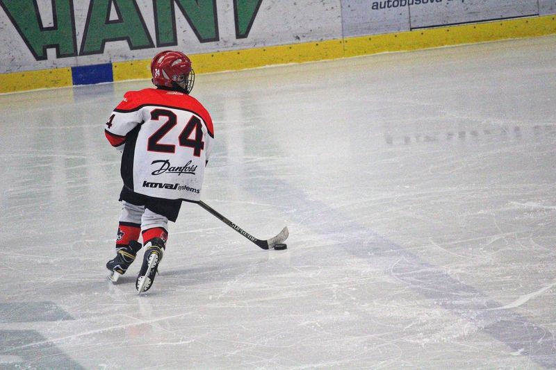 A youth ice hockey player on the ice inside a hockey arena