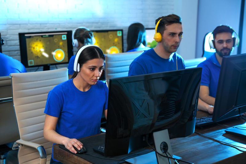 an esports team gaming together on computers