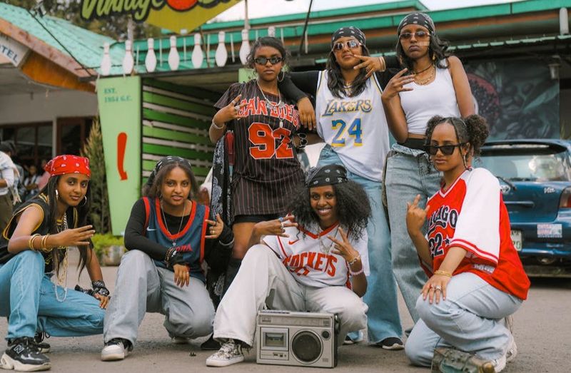 a group of young women wearing streetwear style clothing