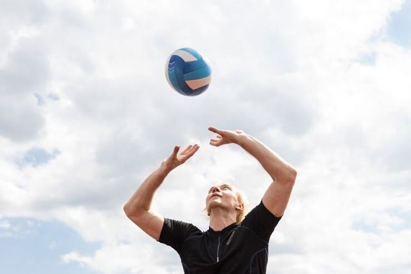 A volleyball player about to hit a volleyball