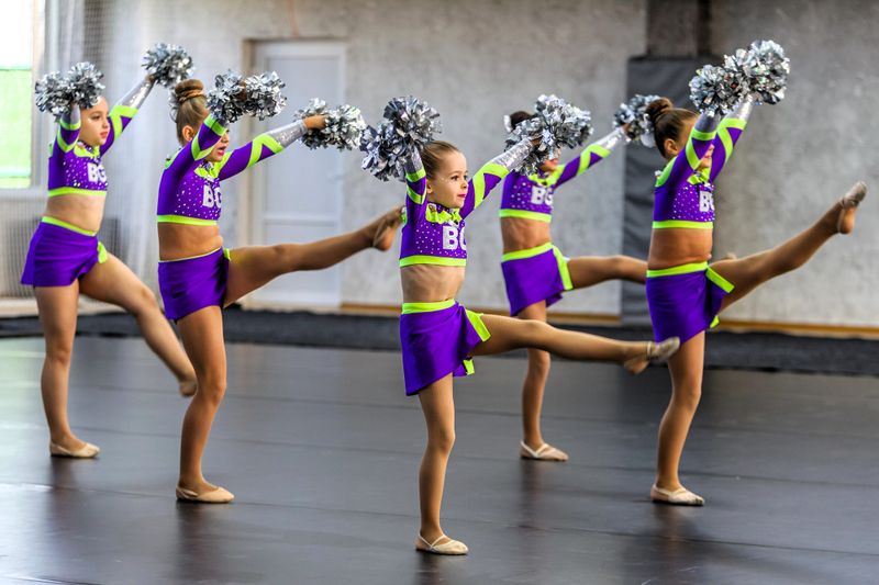a youth cheerleading squad going through a cheer routine