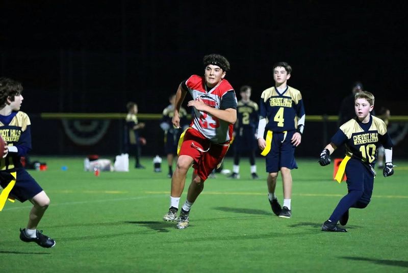 a flag football player running running to block a pass