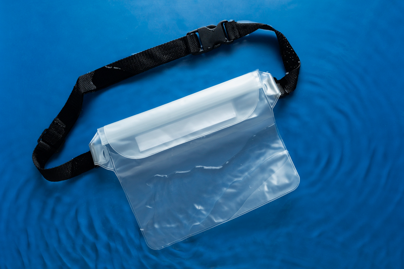 a clear fanny pack that are used in sports stadiums against a blue background