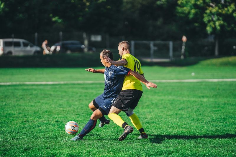 two soccer players on a soccer field