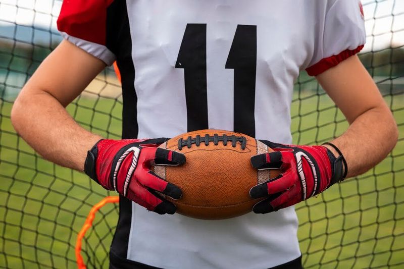 athlete wearing football gloves