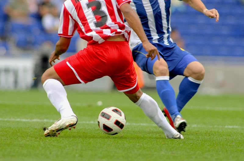 two soccer players on a soccer pitch