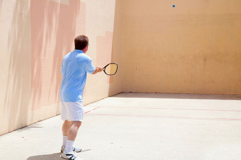 a racquetball players practicing wall hits alone