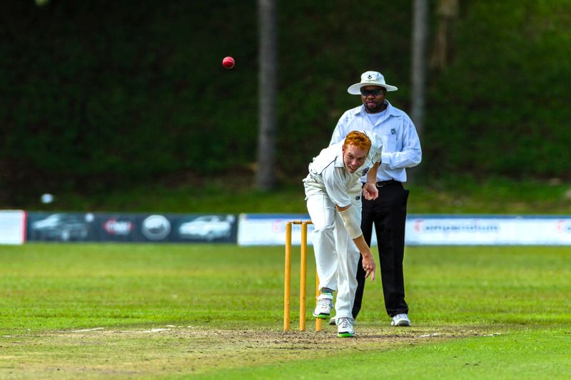 a cricket bowler throwing a cricket ball