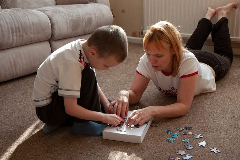 Mum helping son with a puzzle