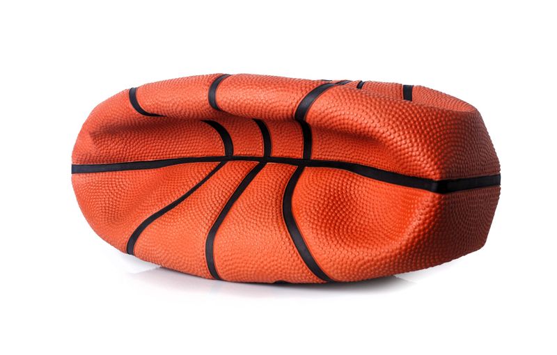 a deflated basketball against a white background