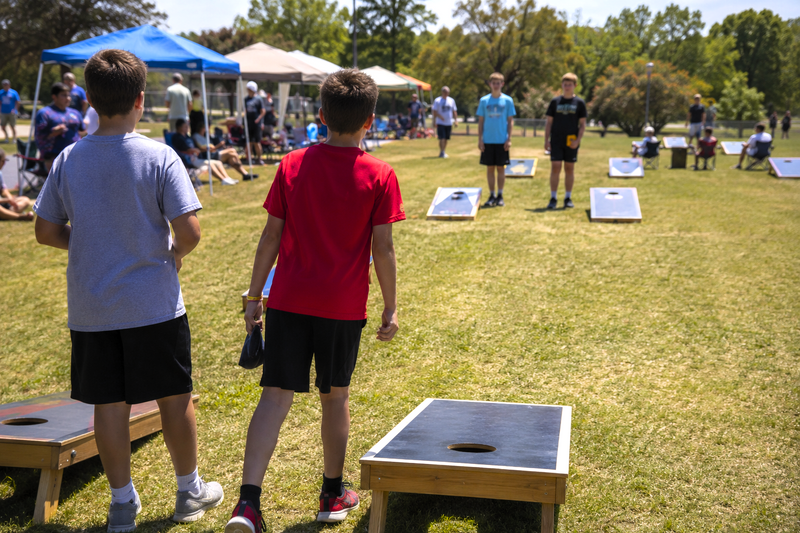 a youth cornhole tournament with two person teams playing cornhole