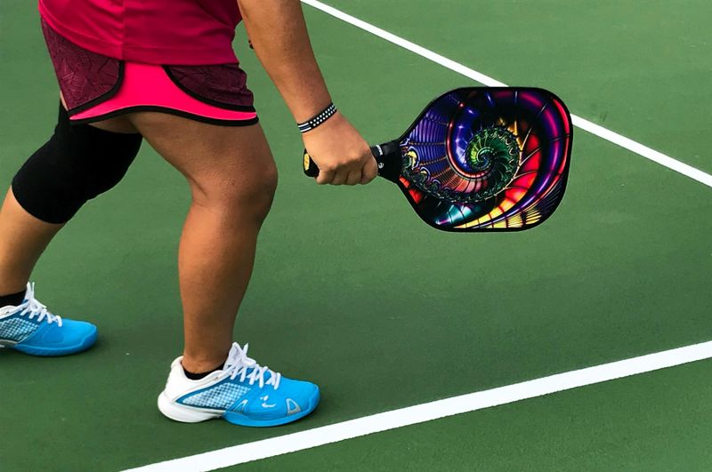 a pickleball player holding a pickleball paddle