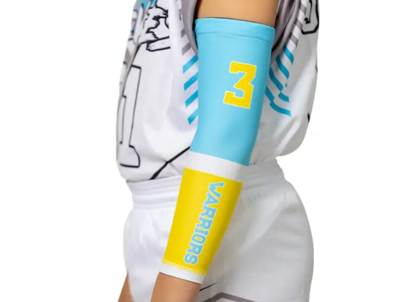 a youth basketball player wearing a blue, yellow and white arm sleeve