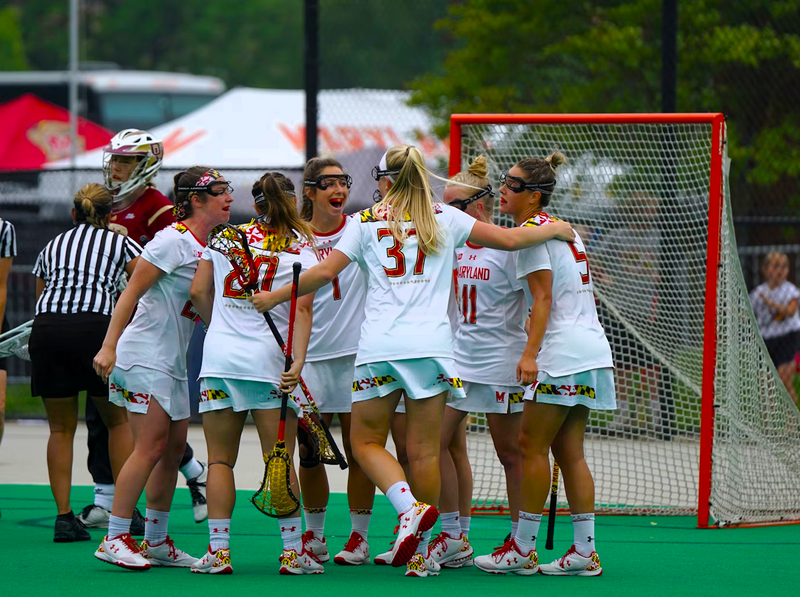 a female lacrosse team in a huddle