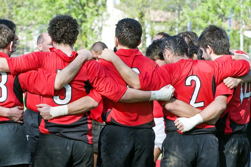 a rugby team in a huddle