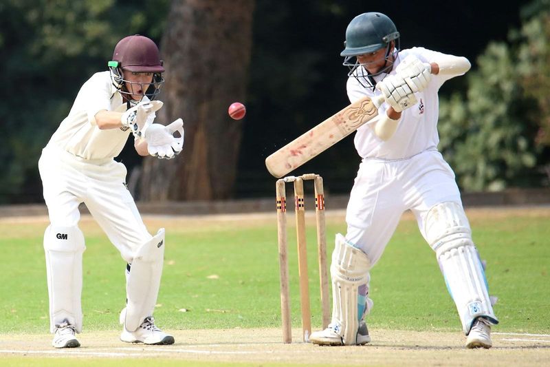 two cricket players engaging in a cricket game