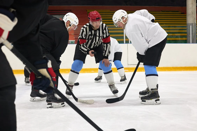 ice hockey players with a referee