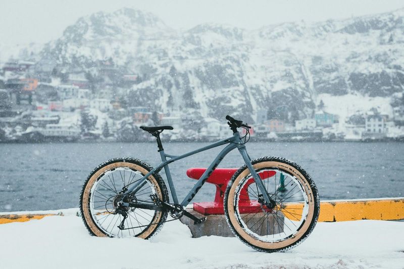 a bicycle on a snowy harbor front 