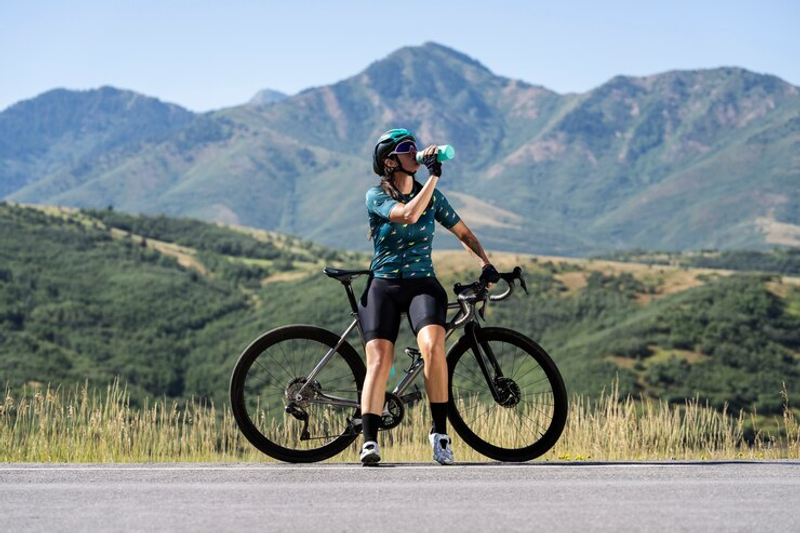 a female bicyclist drinking water