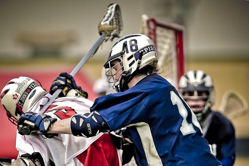 lacrosse players playing a lacrosse match