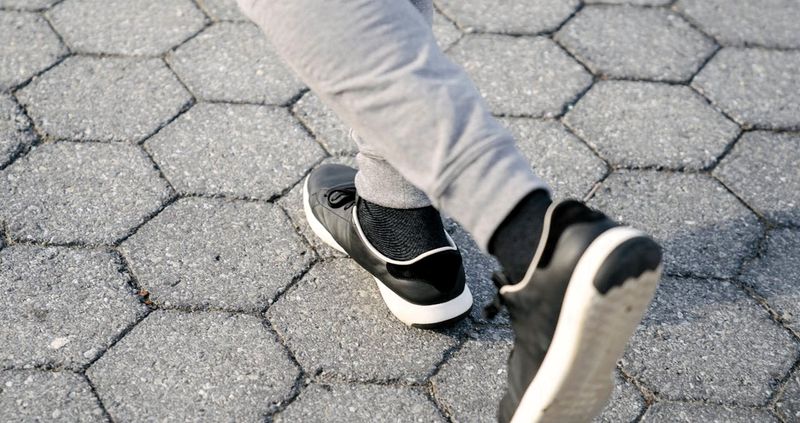 a man running on a sidewalk wearing cotton track pants