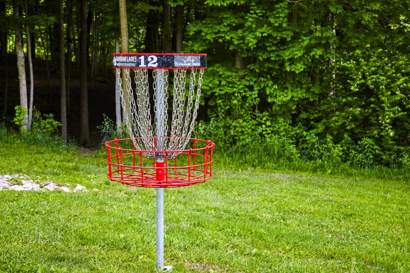 a red disc golf basket with the number 12