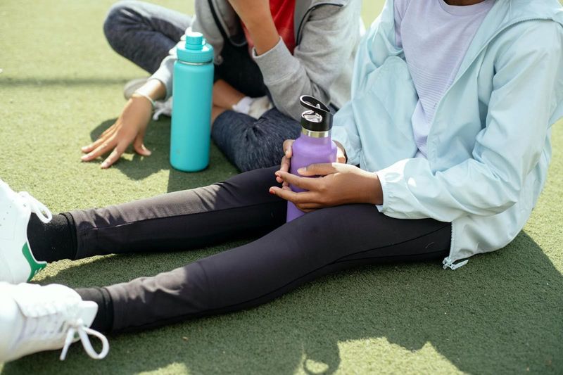 person holding a sports water botle