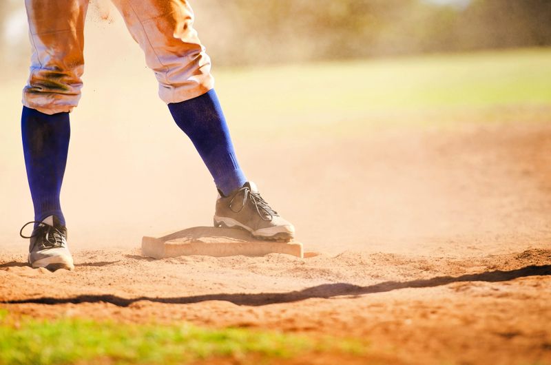 a softball player standing on a base