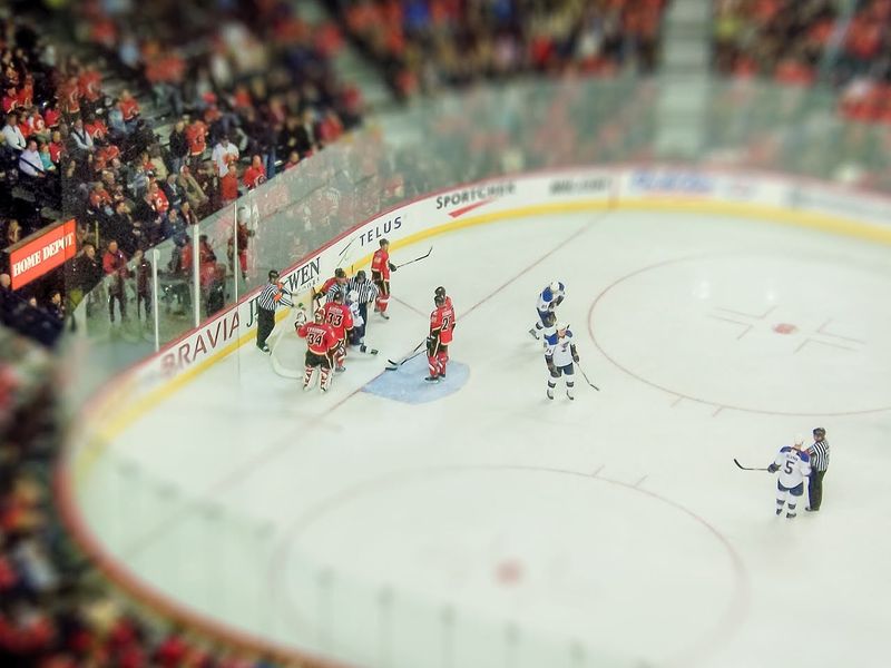 Ice hockey players on the ice inside a hockey arena