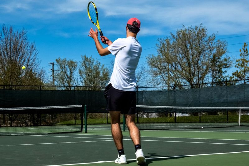 a man playing tennis on a tennis court