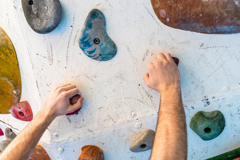 a man climbing on an indoor climbing wall