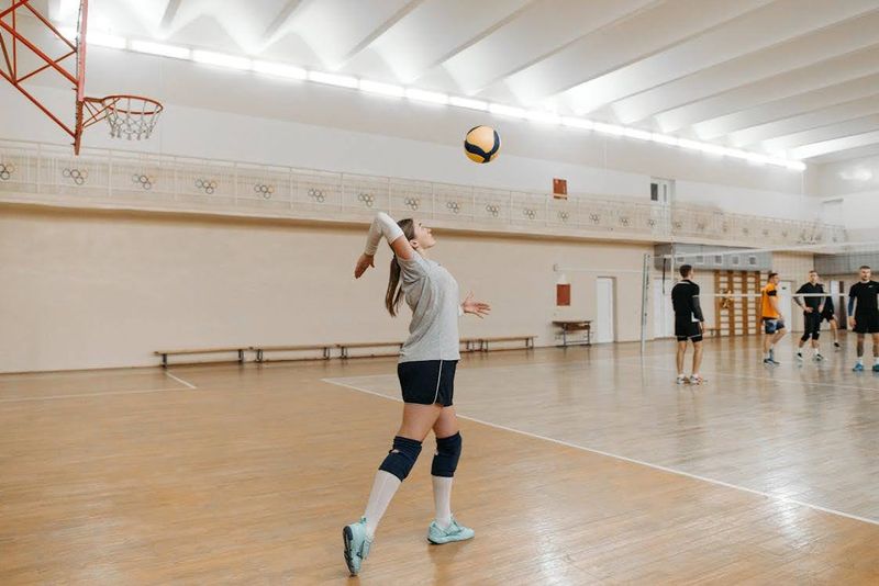 A girl serving a volleyball