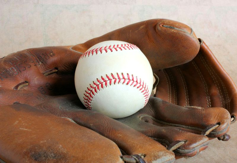a softball inside a leather softball glove