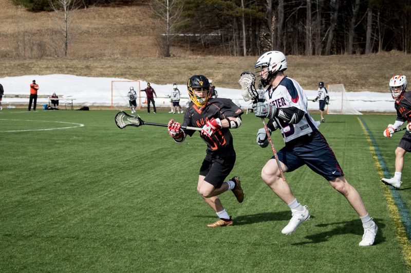 two lacrosse players playing lacrosse