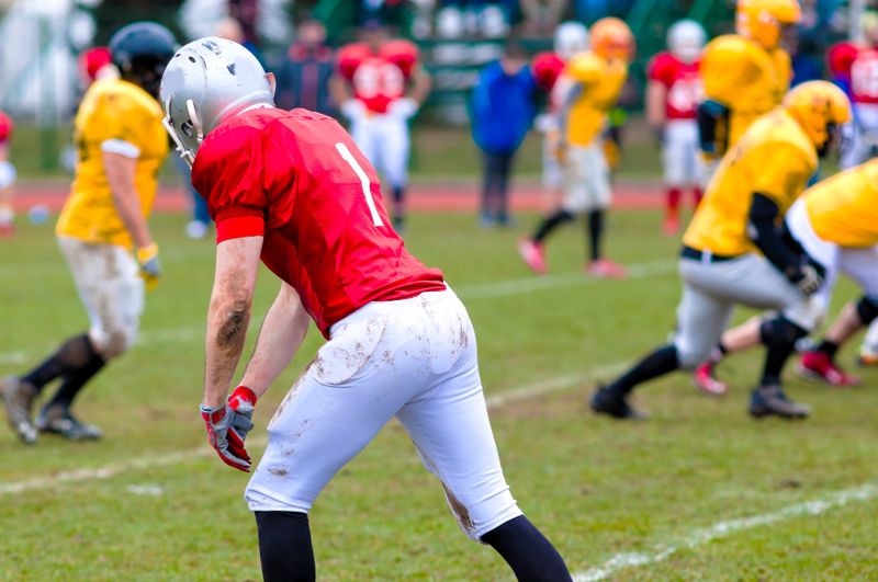 a football player preparing to run to catch a football