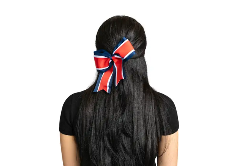 a female with a cheer bow tied to her ponytail