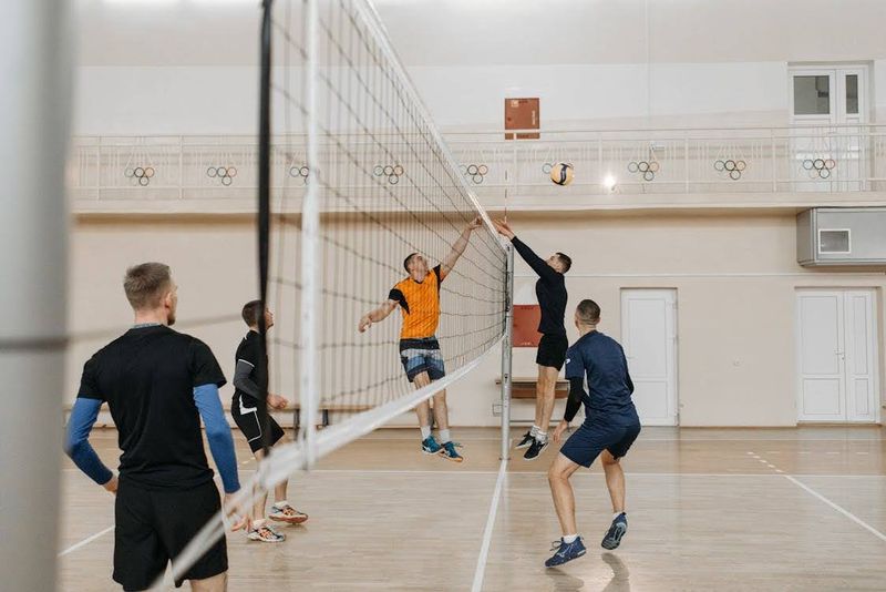 Volleyball Players defending a spike ball