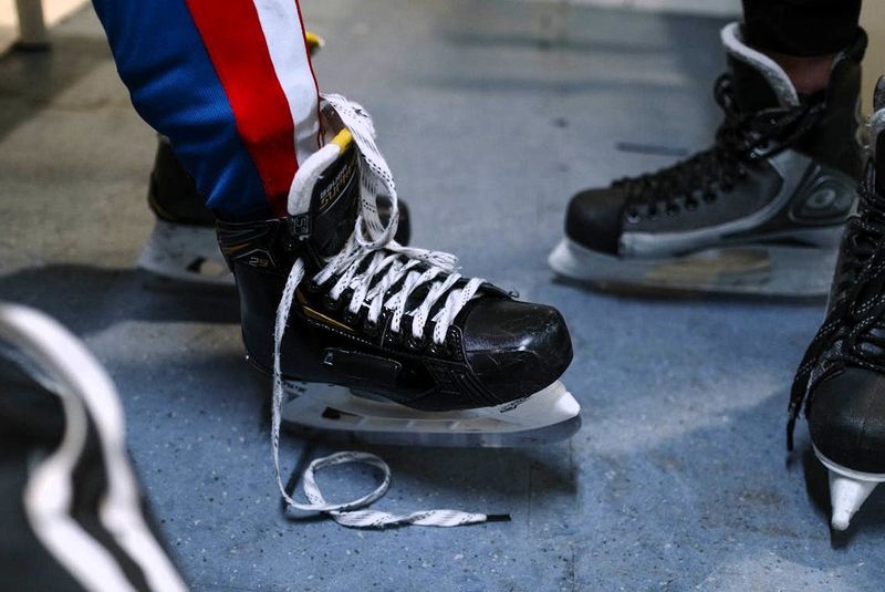 a hockey player wearing ice skates in a locker room