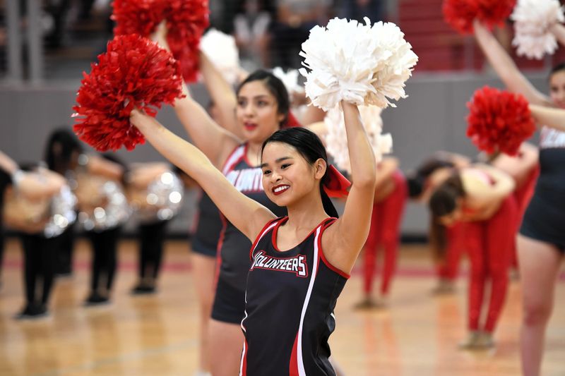 two female cheerleaders in a cheer pose