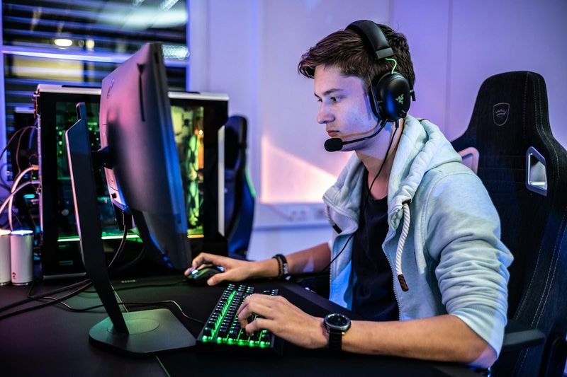 an esports team member gaming on a desktop computer