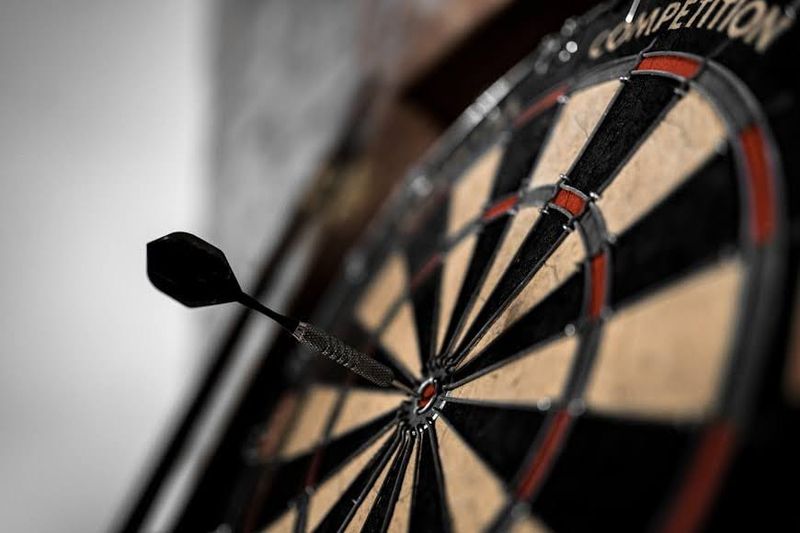 a single dart in the bullseye on a dart board