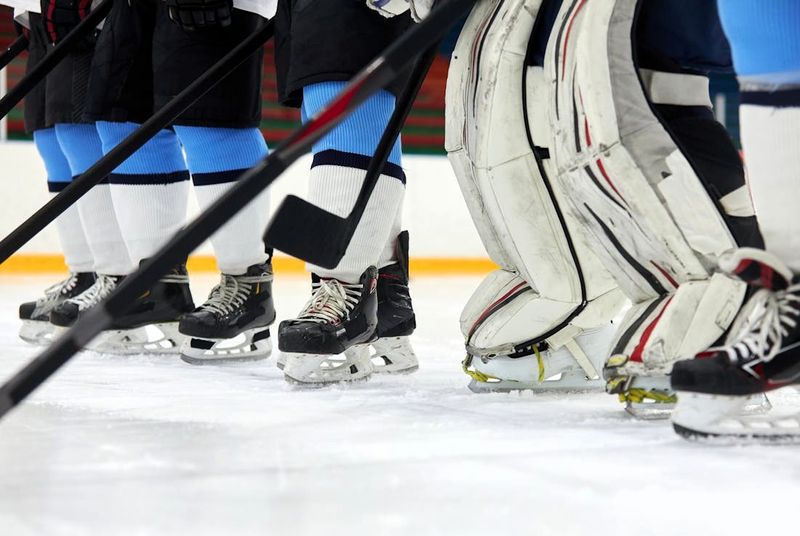 a close up of a hockey team's hockey socks on an ice rink